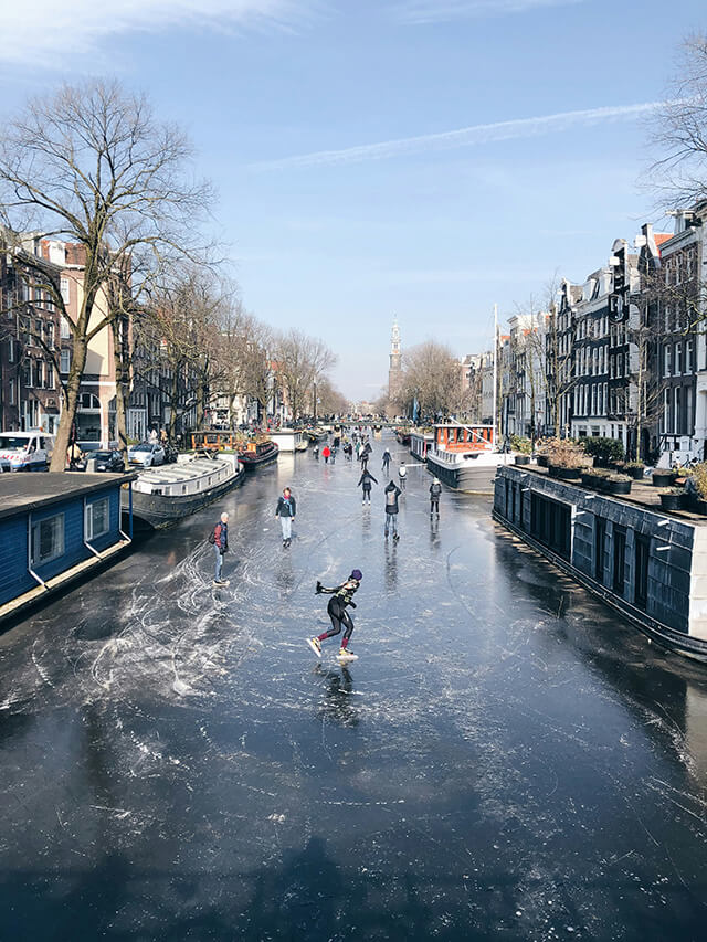 view of an ice rink with people skating on it